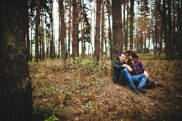 young couple relaxing under a tree