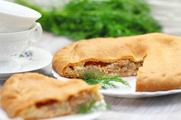 Pie with red fish and rice