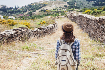 Hiker traveler woman on a hiking trail, travel and active lifestyle concept