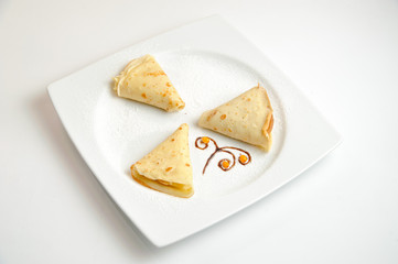 blinz on a white isolated plate with yellow berries for menu photoshoot