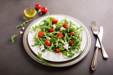 fresh vegetable salad with rucola, tomatos and goat cheese. Healthy food concept. Copy space.