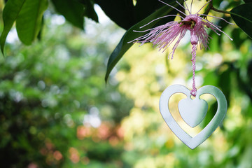 Silver heart hang on a tree with love