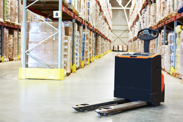 Pallet truck at warehouse © Kadmy