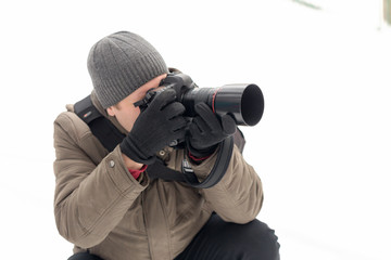 Fototapeta na wymiar photographer taking pictures in the forest in winter