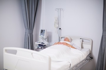 Senior woman patient sleeping on bed