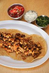 Mexican tacos with chirmol, onions and sauce.