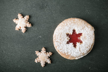 Obraz na płótnie Canvas Homemade cookies with jam, shortbread on a black slate table. To