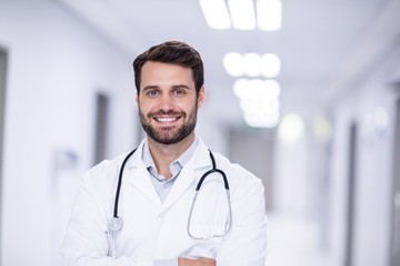 Portrait of male doctor standing with arms crossed - Powered by Adobe