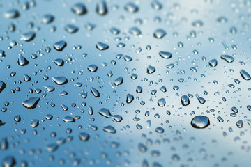 Water drop on the mirror with blue background tilt shift effect