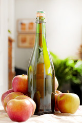 bottle of cider with fresh apples