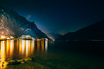 Scenic night view of illuminated town Limone sul Garda, Italy - obrazy, fototapety, plakaty