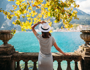 Young woman relaxing on beautiful Garda lake - obrazy, fototapety, plakaty