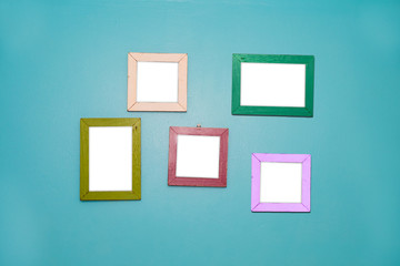 5 Empty vintage frame isolated on blue cement wall.