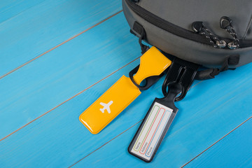 Close up of blank luggage tag label on suitcase or bag with travel insurance. Travel insurance label tied to a backpack.