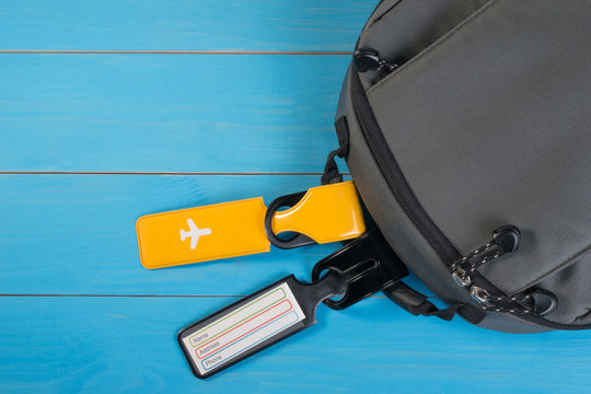 Close Up Of Blank Luggage Tag Label On Suitcase Or Bag With Travel Insurance. Travel Insurance Label Tied To A Backpack.