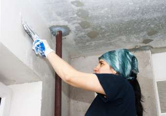 young pretty woman geting plaster wall