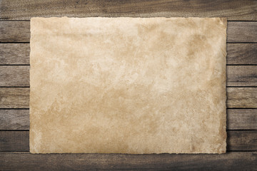 Old paper sheet at wooden background  clipping path