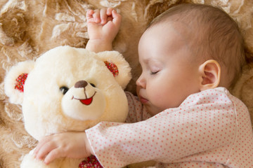 Baby sleeping with teddy bear