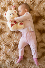 Baby sleeping with teddy bear
