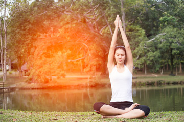 Young woman doing yoga in morning park