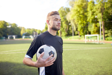 soccer player with ball on football field