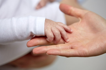 close up of mother and newborn baby hands