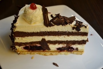 Detail of a black forest cake with white dessert plate