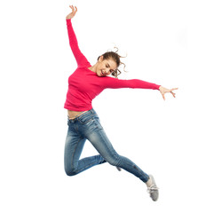 happy young woman jumping in air or dancing