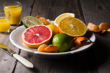 Fototapeta na wymiar various types of citrus fruit on a dark wooden background