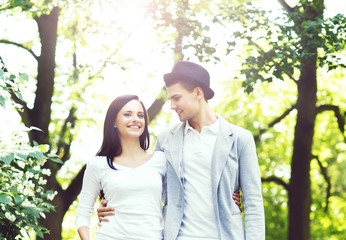 Fototapeta premium Young beautiful couple having a date in the park. Love, relationship, dating: concept.