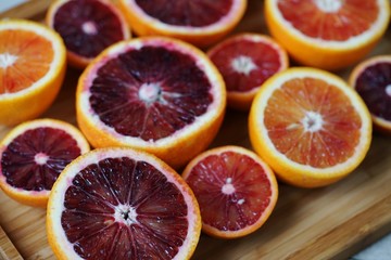 Tray of ruby red blood oranges cut in half 
