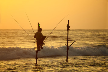 GALLE, SRI LANKA - JANUARY 05: An unidentified Sri Lankan stilt fisherman sits still on a single...