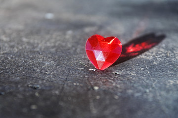 Fototapeta premium Red love heart with reflection on gray stone, valentine's or mother's day