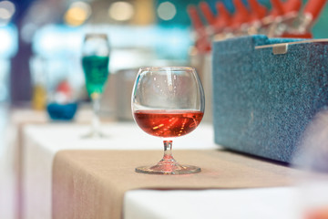 Glass of red wine. Festive cocktail in a cafe restaurant. Backgr