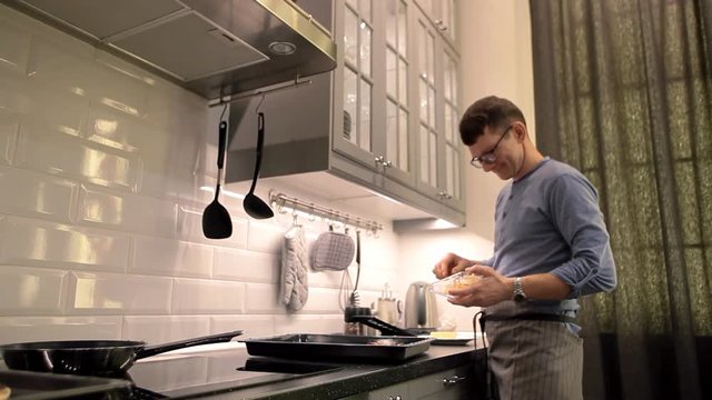 man preparing pizza in the kitchen at home. ingredients