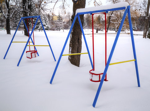 Children's playground covered with snow in winter