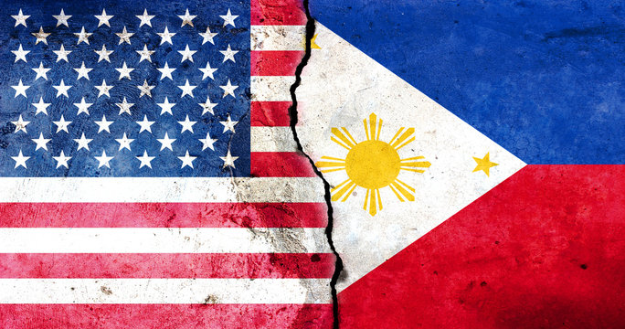 A large crack in the wall. USA flag. Flag of the Philippines