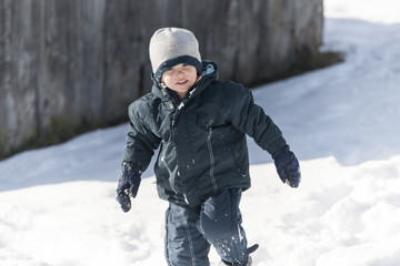 Fototapeta na wymiar Cute little boy, playing in the snow