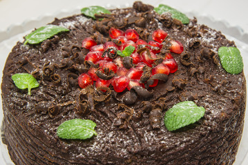 chocolate cake decorated with pomegranate seeds