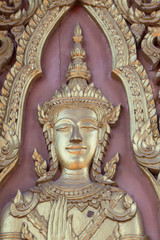 Fototapeta na wymiar Sculpture, wood carving on the door. According to Buddhist belief