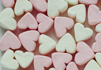 background of pink and white marshmallow hearts. macro 