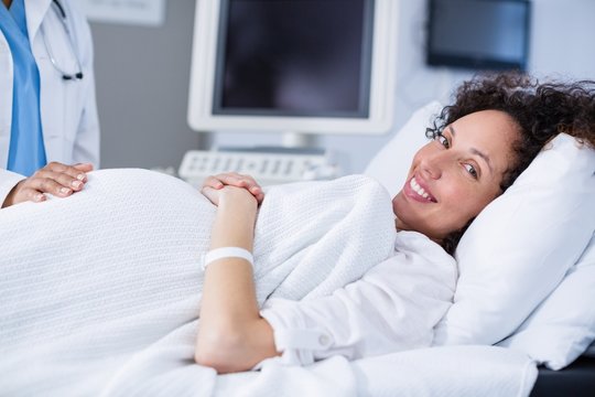 Portrait of pregnant woman smiling during ultrasound scan