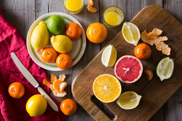 various types of citrus fruit on a wooden background