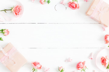 Flowers composition. Gifts and rose flowers on white wooden background. Valentine's Day. Flat lay,...