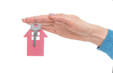 Key from the house in a female hand.