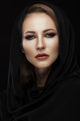 Naklejka premium Beautiful girl in the Arab scarf with oriental make-up. Beauty face. Photos shot in the studio.