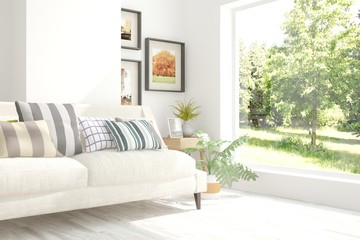 Modern interior design with sofa and green landscape in window