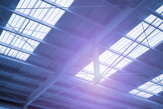 Industry ceiling with purple light rays in cyanotype picture style 