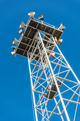 Speakers broadcast tower with a blue sky