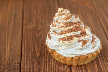  protein cake with cream and chocolate on a brown wooden table
